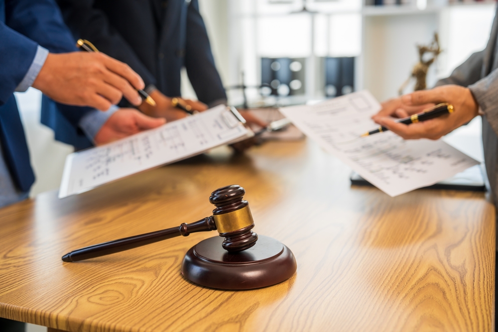 business-people-signing-documents-at-a-table-during-a-meeting