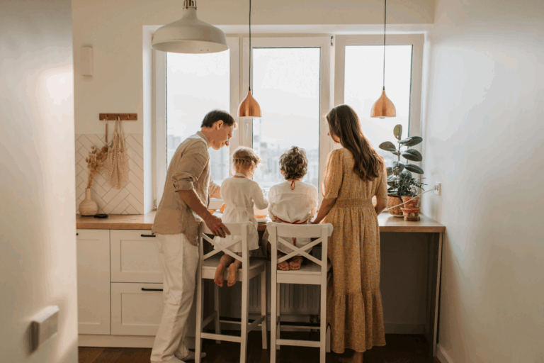 Young family gathered in a cozy kitchen, highlighting the need for more space in their growing home