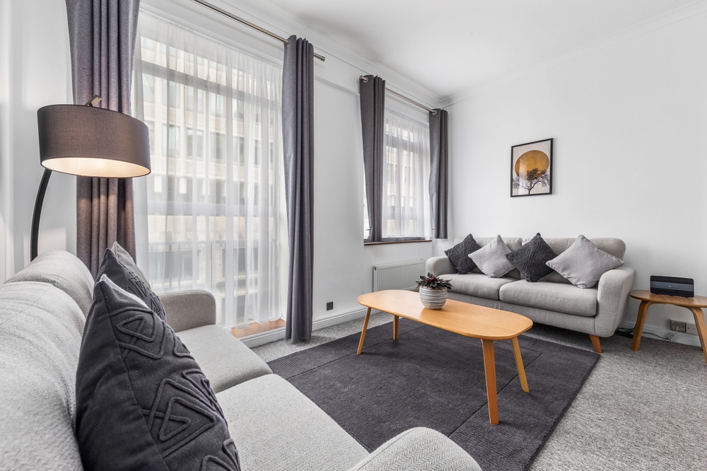 Living room featuring grey couches and a coffee table.