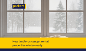 Snow falling outside a window with a blanket on the sill, illustrating Parkers’ guide on how landlords can get rental properties winter-ready.