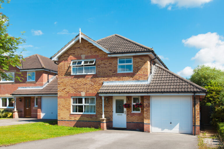 A large house with a garage in a suburban setting.