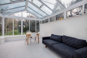 A sunroom featuring a spacious glass roof, allowing natural light to fill the space.