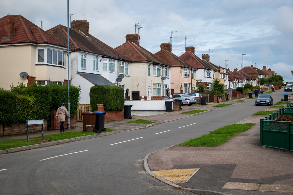 A row of colorful houses lined up along a street.