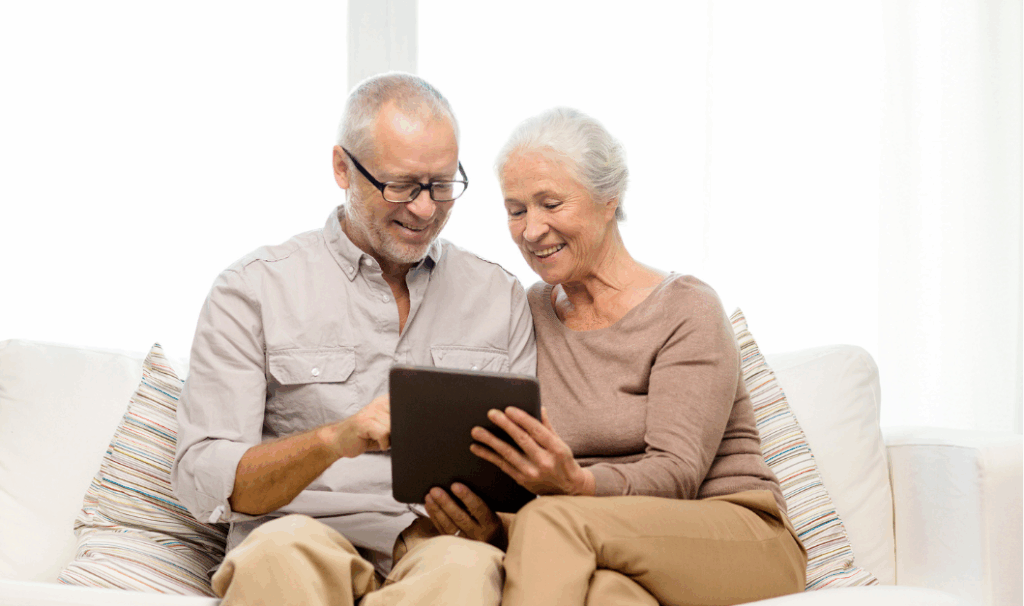 Older couple reviewing house pricing information on a tablet at home.