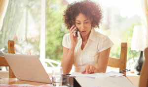 Landlord reviewing rental income paperwork while updating digital tax records for Making Tax Digital