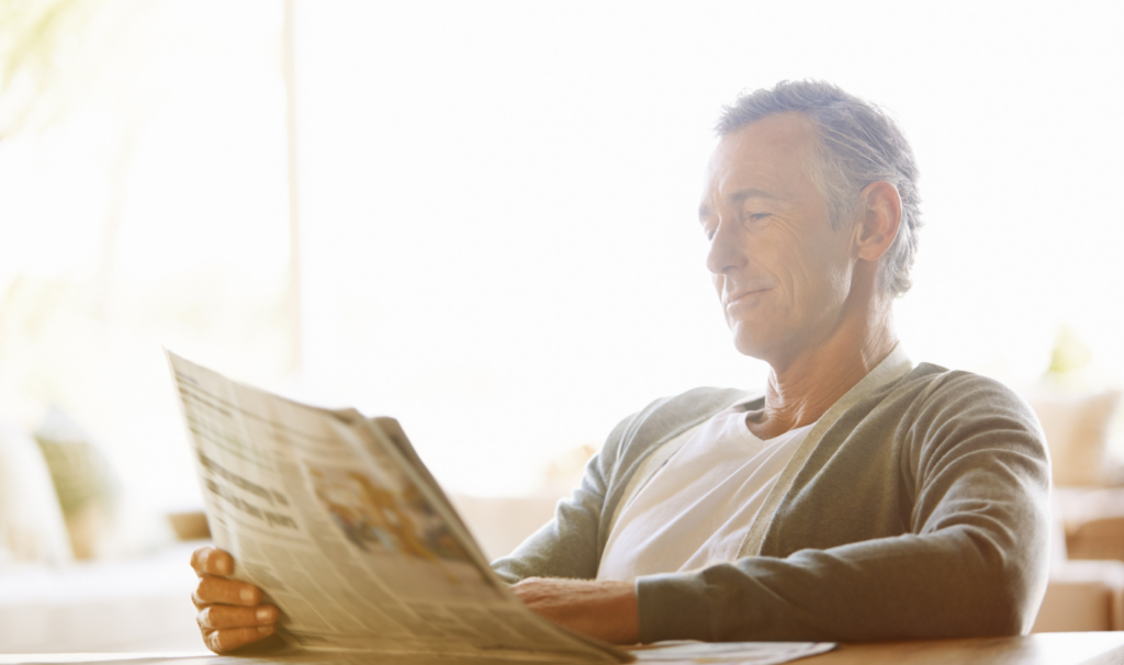 Landlord reading property news about rental rules at home