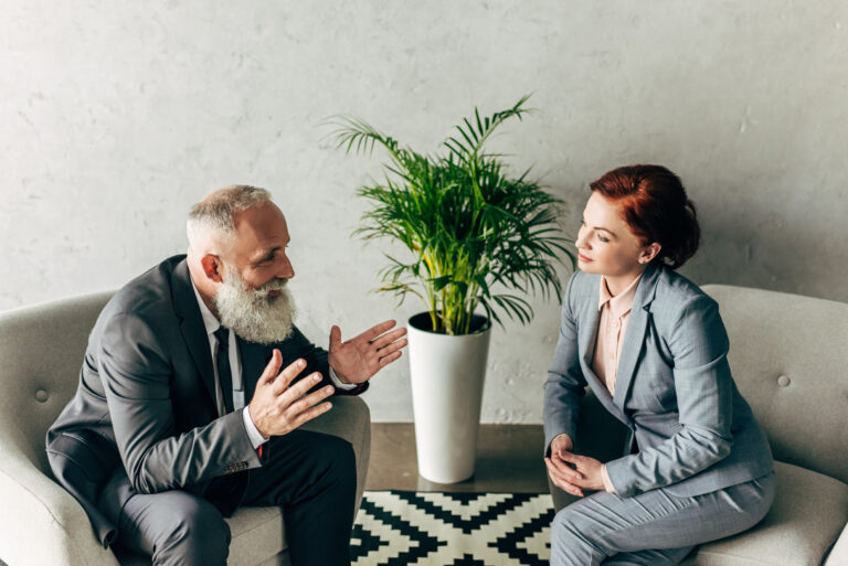 Landlord discussing tenancy issues with property professional in modern office