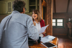 Landlord and tenant reviewing tenancy documents at a table, illustrating rent in advance and Renters’ Rights Act changes in the UK rental market
