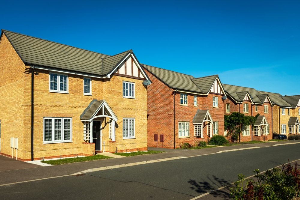 A row of suburban british houses lining a quiet street.