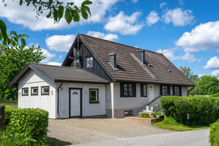 House with a garage, featuring a well-maintained exterior and a driveway.