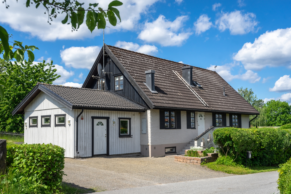 House with a garage, featuring a well-maintained exterior and a driveway.