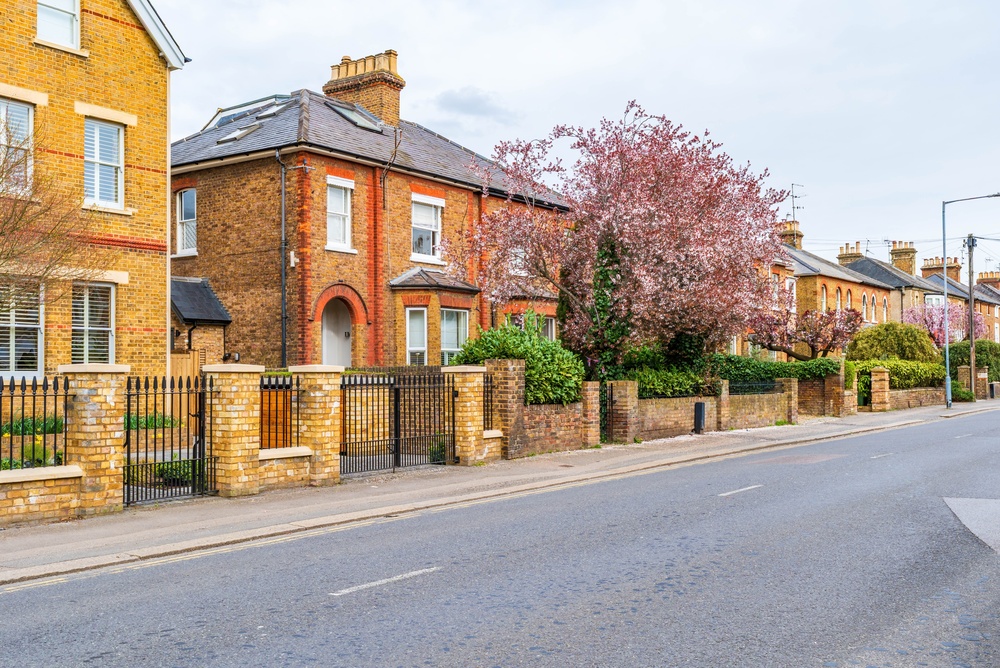 A row of colorful houses lining a quiet residential street.